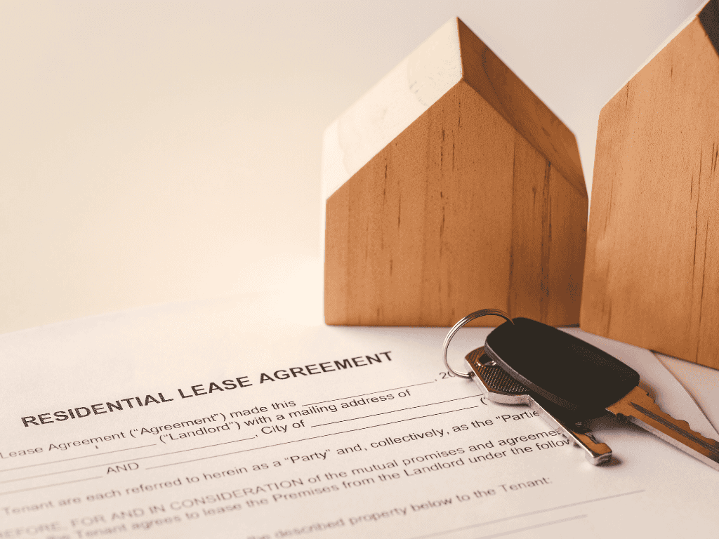 photo of a lease agreement and pair of keys sitting on a desk.